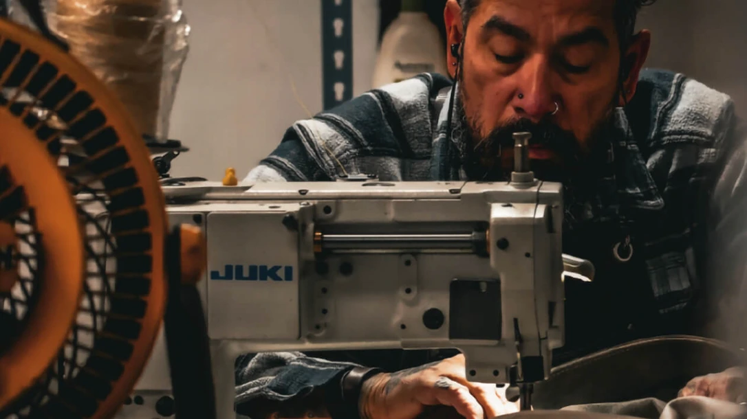 An employee at EarthRoamer stitches the custom upholstery.