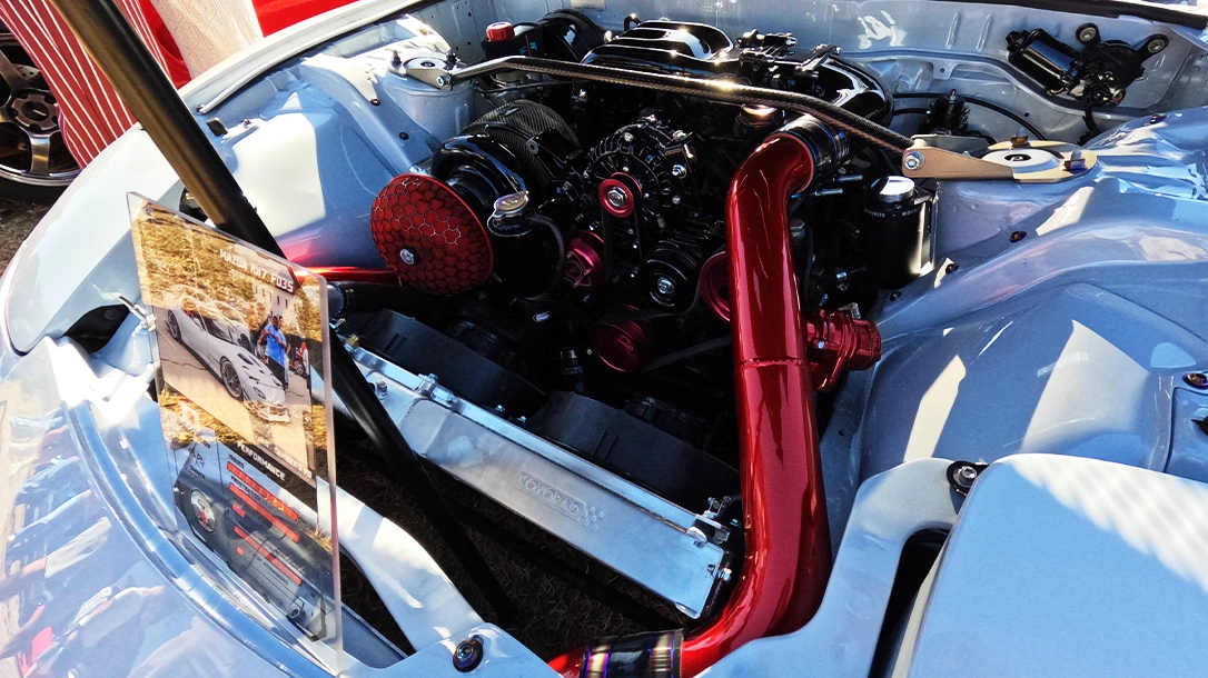 A highly customized engine bay in a Mazda RX-7, complete with a Rotary engine.