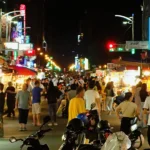 The night market buzzes with energy as vendors showcase an array of tantalizing street foods.