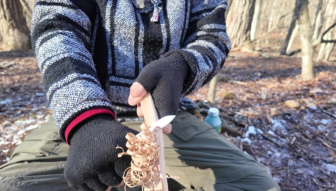 Essential winter tools: the trusty Nata, buck saw, and a makeshift hobo stove—simple, rugged, and reliable.