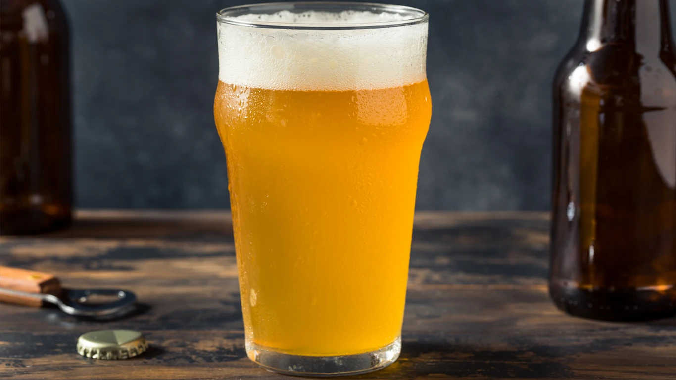A freshly poured glass of craft beer, showcasing its golden color and frothy head.
